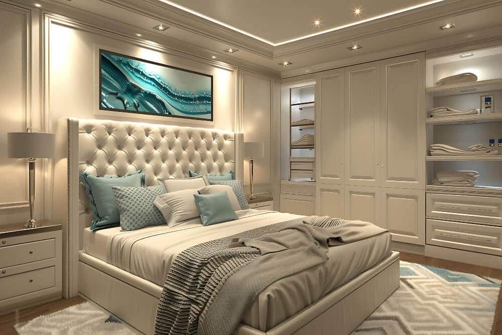 Luxurious bedroom featuring a tufted headboard, blue and white bedding, built in shelves, overhead lights, and premium mattresses & sleep essentials for the ultimate comfort.