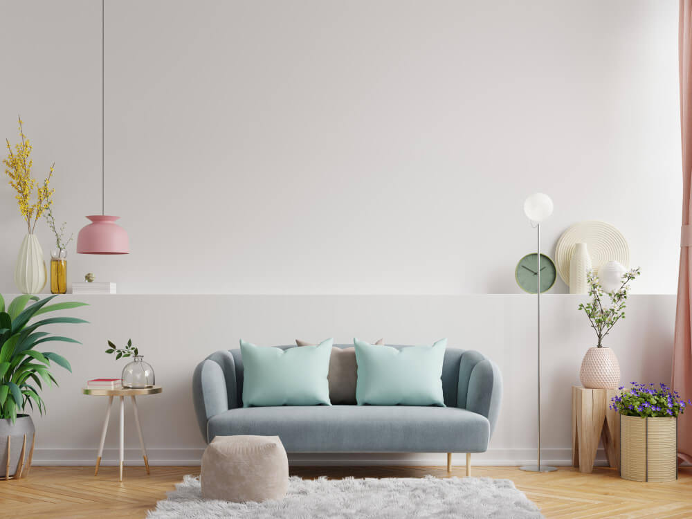 Blue color sofa with pillows and potted plants