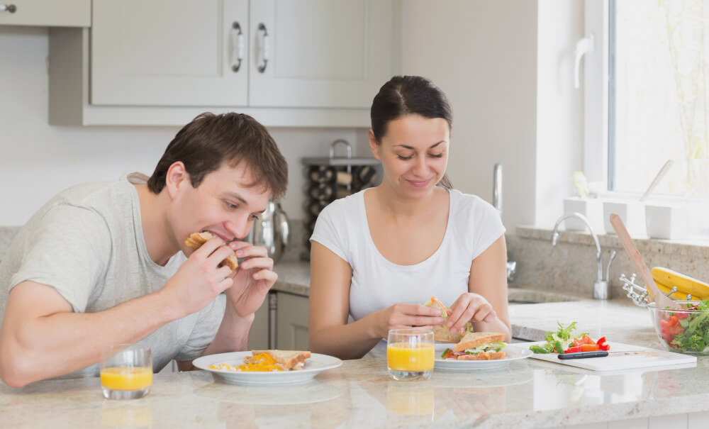 Couple enjoying a meal in the kitchen