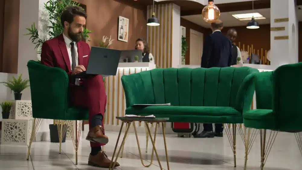 Businessmen checking his laptop in a hotel lobby