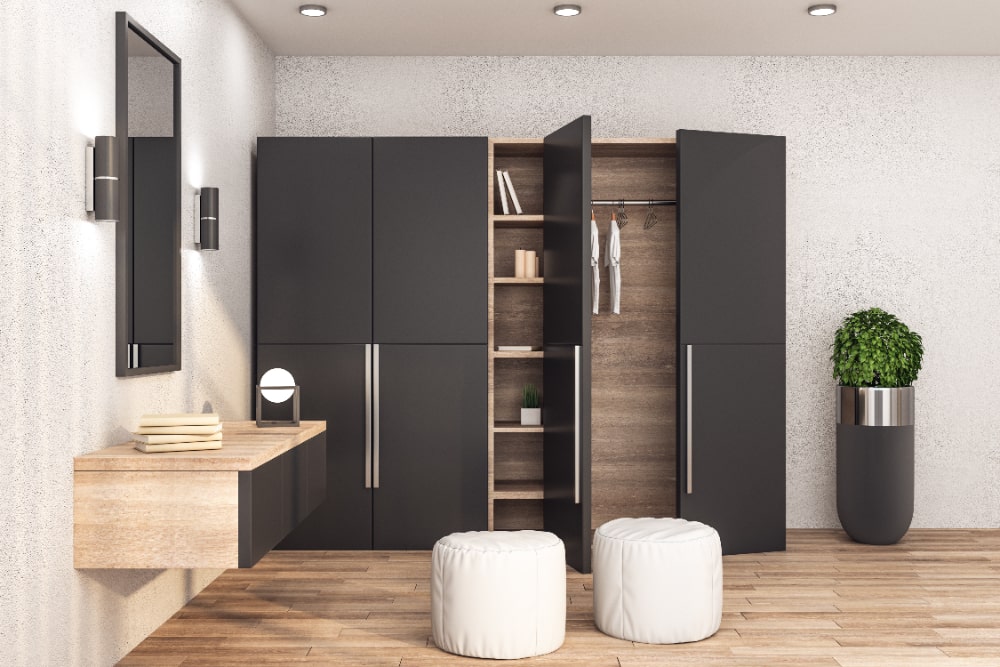 A sleek modern bathroom featuring black cabinets and bright white flooring, creating a stylish and contemporary atmosphere.